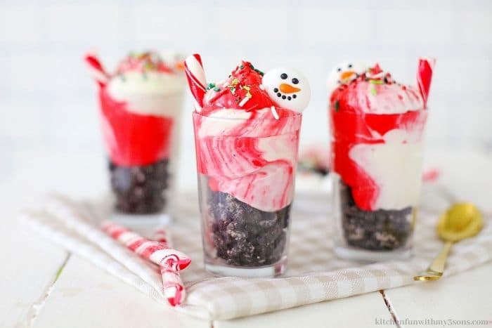 The parfaits with snowman faces and peppermint sticks.