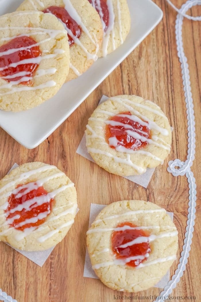 The strawberry thumbprint cookies on a wooden table.