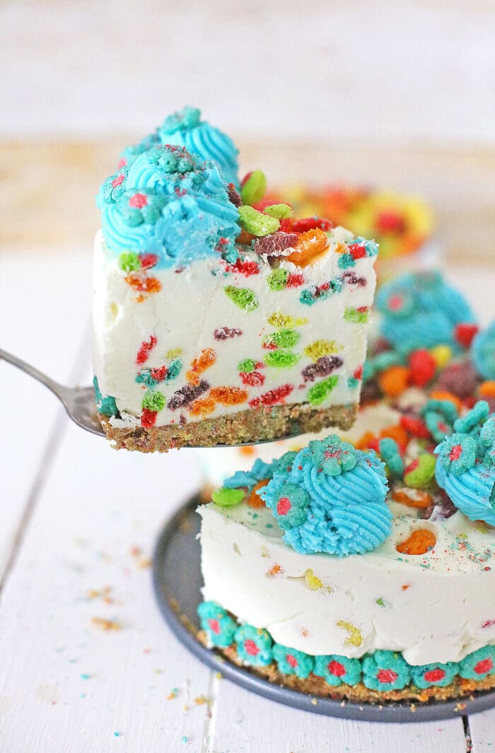 A piece taken out of the Rainbow Trix Cereal Cheesecake.