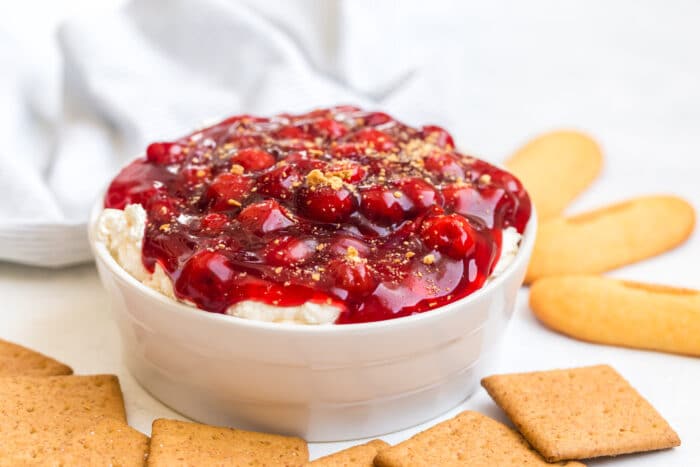 A white bowl full of the Cherry Cheesecake Dip.
