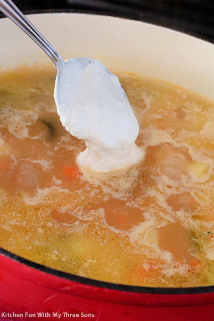 adding the sour cream paste to the soup as a thickener.