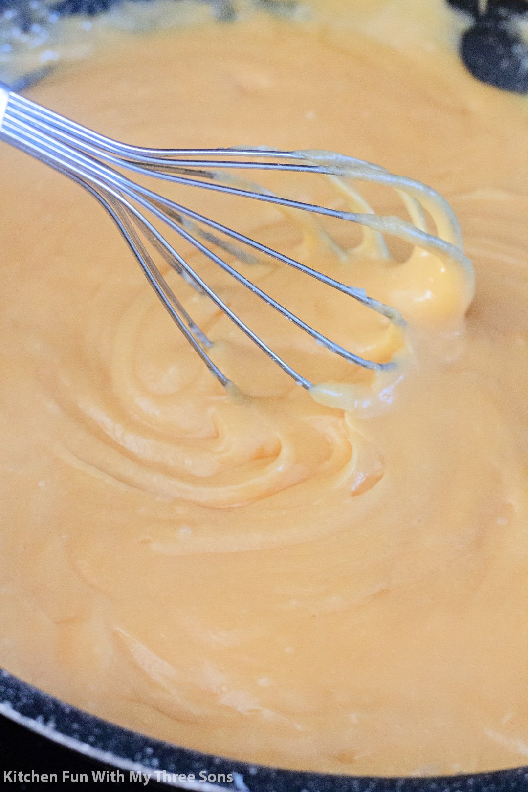 whisking freshly made Homemade Cheese Sauce.