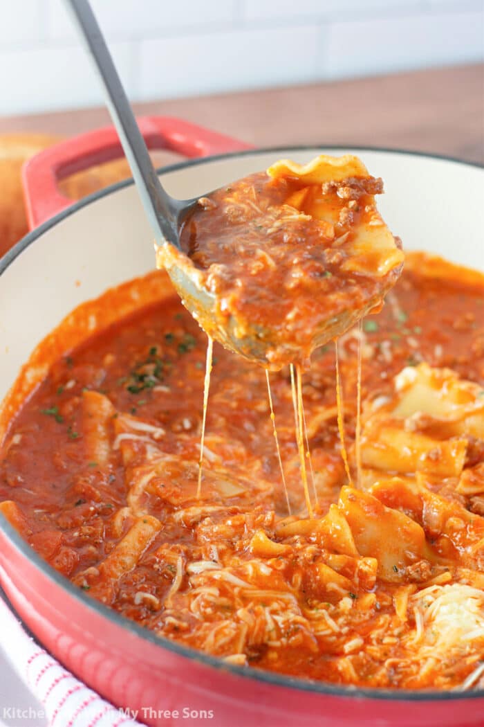 Ladle full of lasagna soup with cheese.
