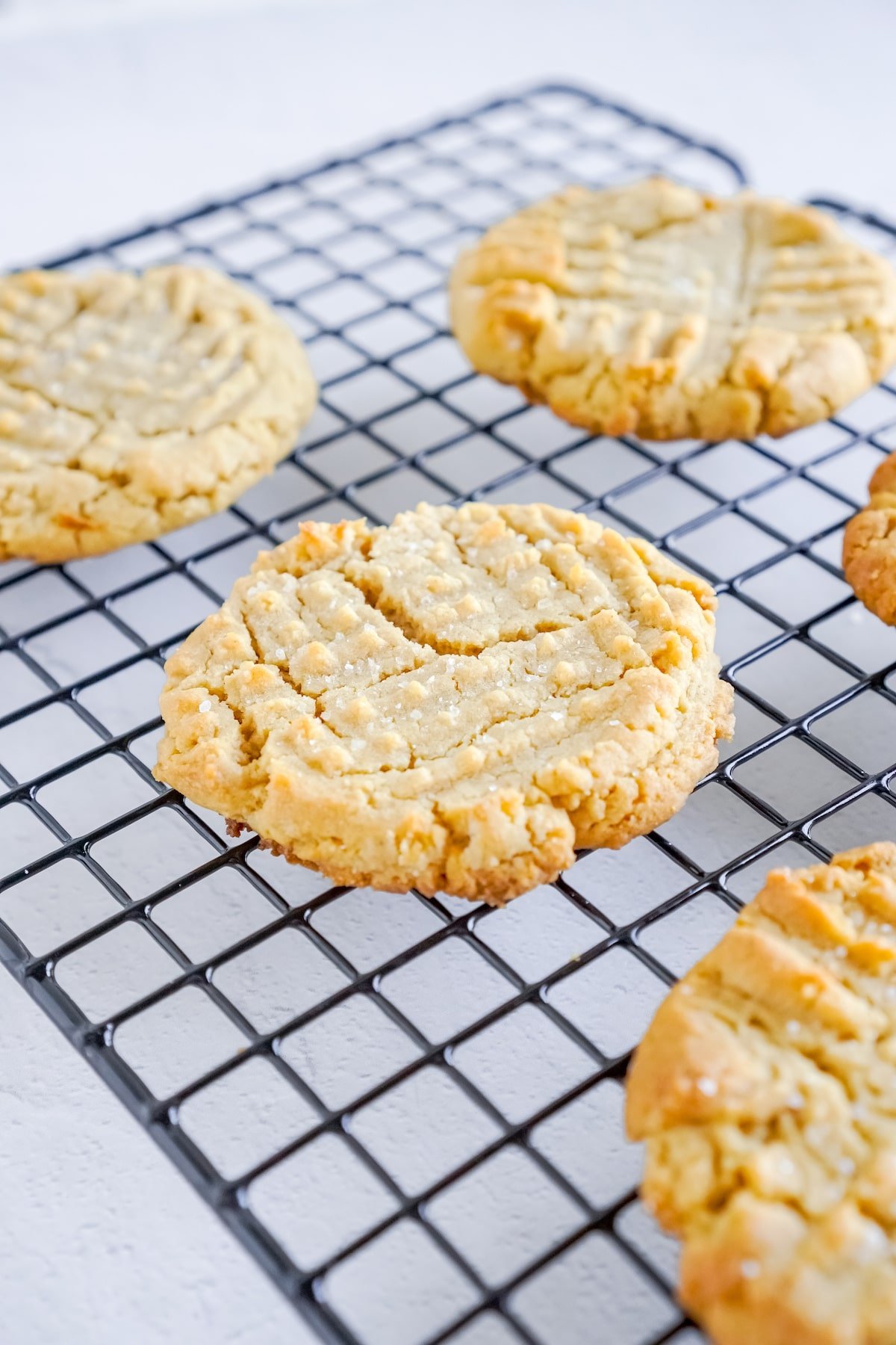 Baked peanut butter cookies on a cooling rack.