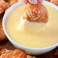 Pretzel dipped in Cheese Sauce