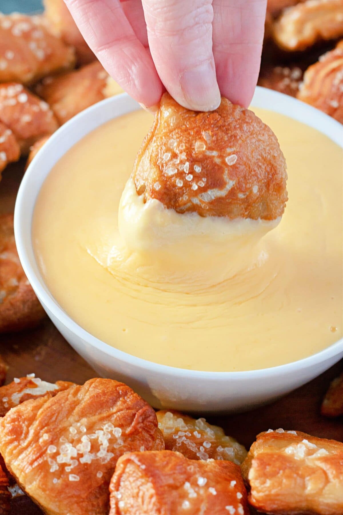 Pretzel dipped in Cheese Sauce