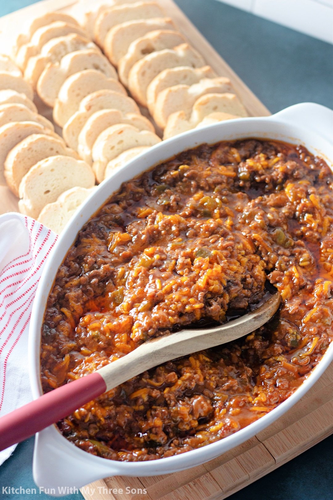 Sloppy Joe Dip in a white dish with a wooden spoon.