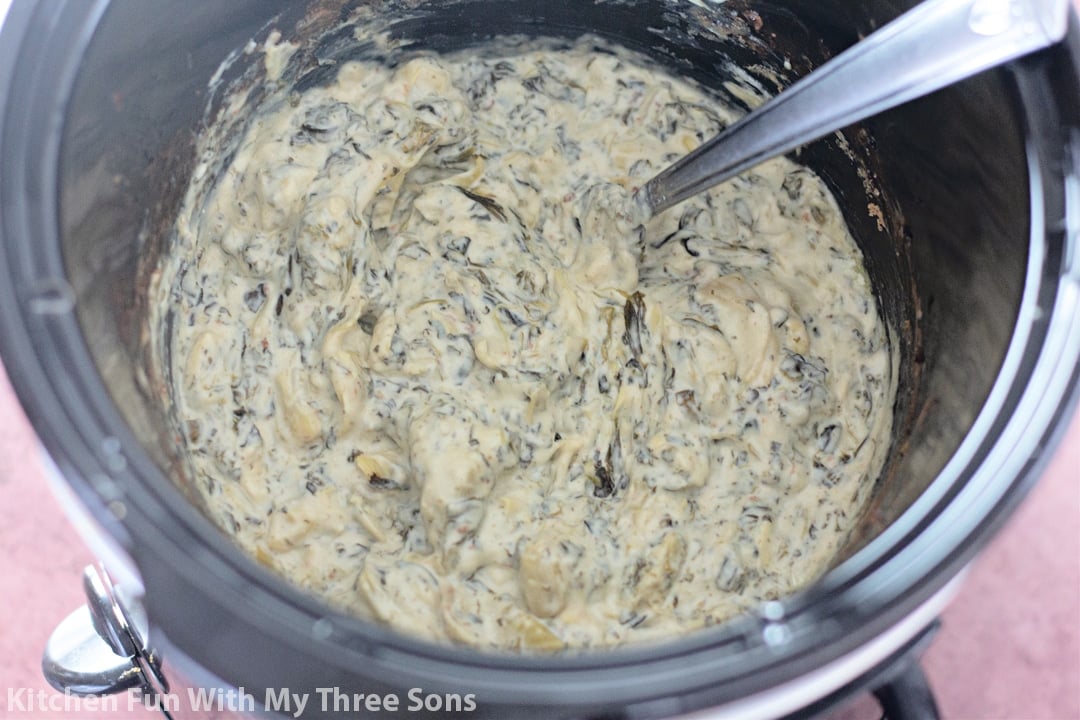 mixing the dip in a crockpot.