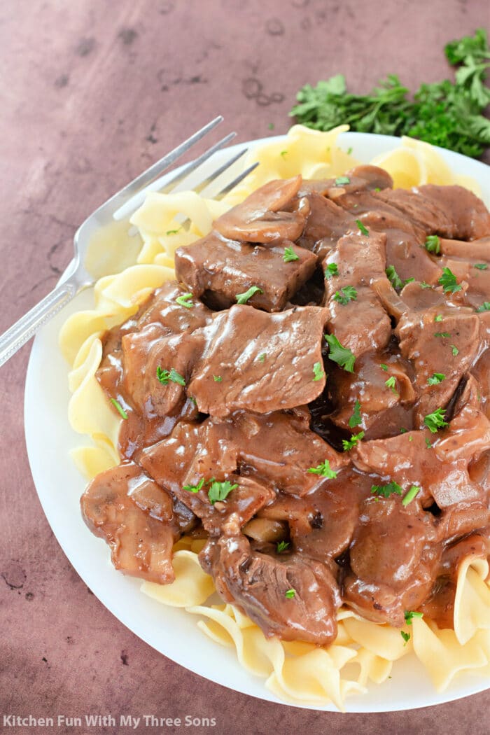 Beef Tips with Gravy on a bed of egg noodles.