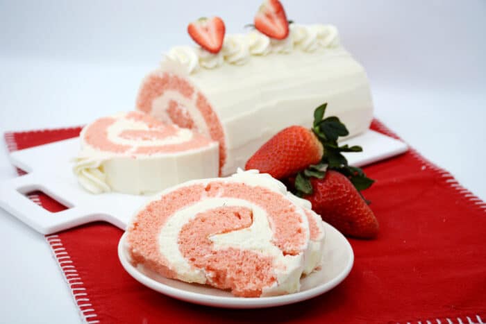 The Strawberry Rolled Cake on a white serving plate.