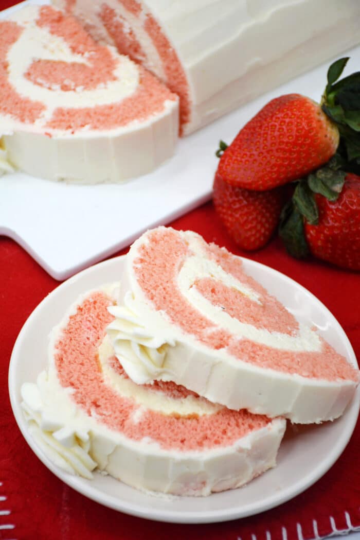 The Strawberry Rolled Cake on red table cloth.
