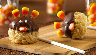 Thanksgiving turkey-themed Rice Krispie dessert balls on top of a wooden cutting board