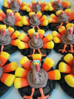 A bunch of colorful turkey cookies lined up on a kitchen countertop