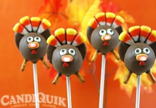 Four Thanksgiving turkey cake pops with candy corn used to decorate them