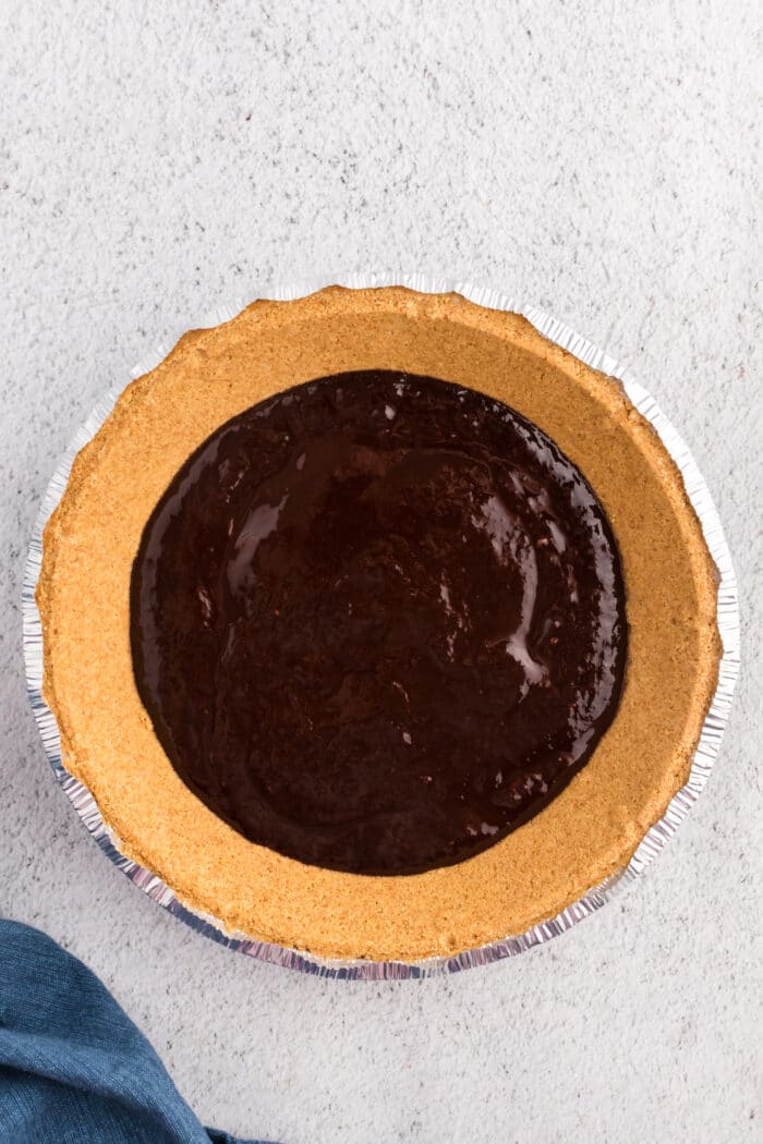Adding the chocolate into the pie.