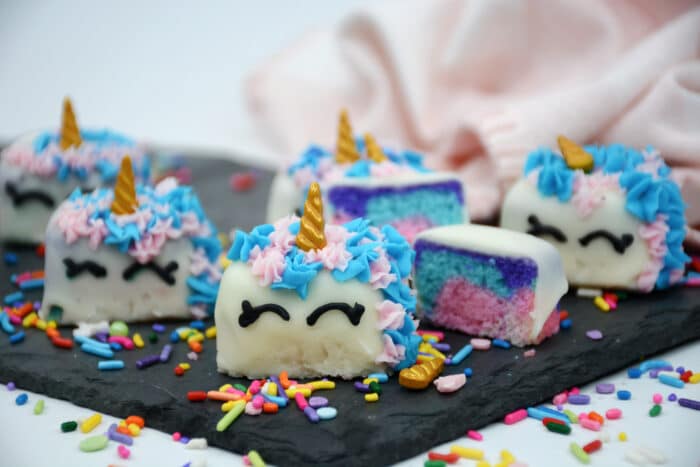 Easy Unicorn Petit Fours Recipe surrounded by sprinkles.