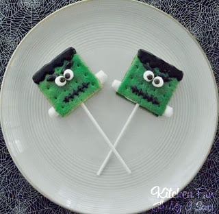 Two s'mores lollipops with Frankenstein faces and arms stuck onto them