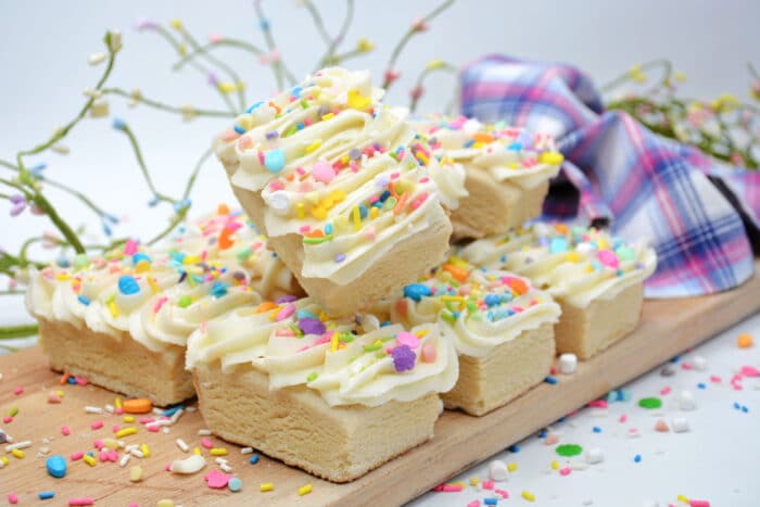 The Frosted Easter Blondies on a wooden board.