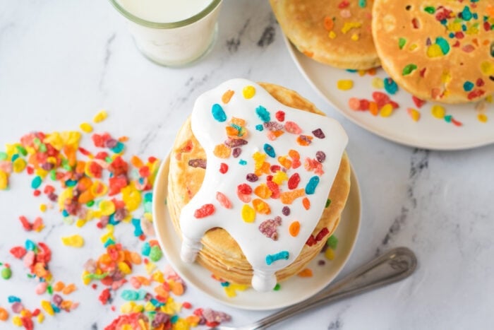 The Fruity Pebble Pancakes topped with marshmallow fluff.