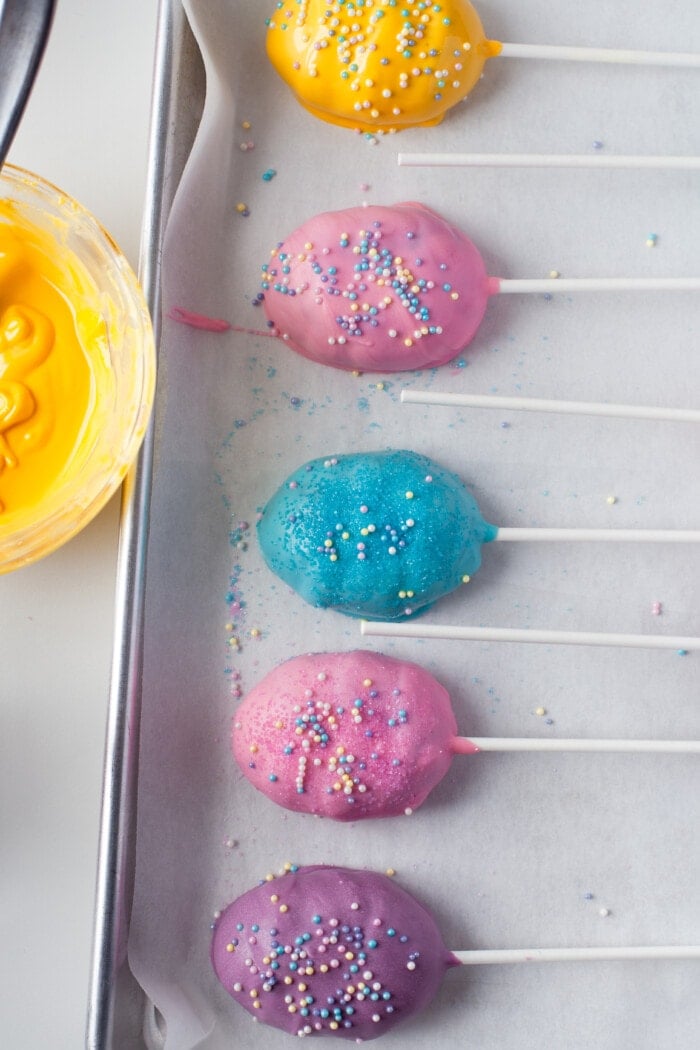 easter egg cake pops on a pan to harden