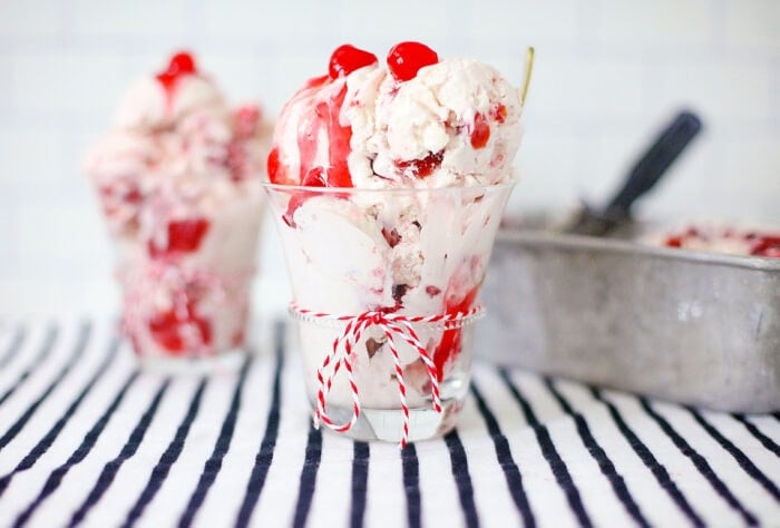 The No Churn Cherry Ice Cream on a black and white table cloth.