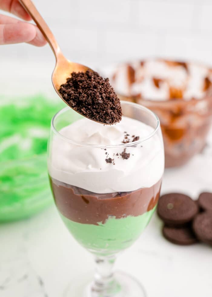 adding cookies layer to the st Patrick's day pudding parfait
