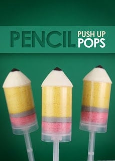 Three pencil push up pops in front of a green backdrop