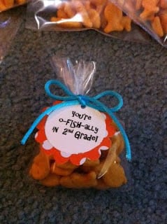 A clear bag filled with Goldfish crackers and tied with a blue ribbon