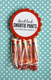 A pouch full of Smarties attached to a small printable sign that says "good luck smartie pants (not like you need it)"