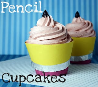 Two frosted cupcakes decorated to look like stubby little pencils