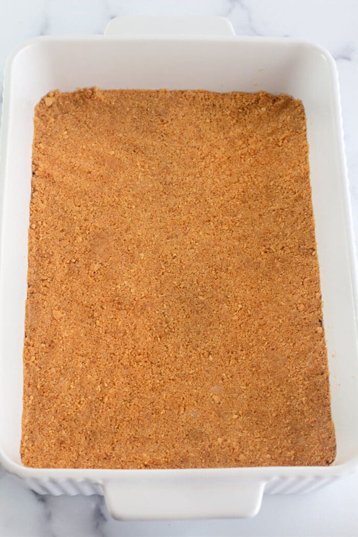homemade graham cracker crust in a white dish.