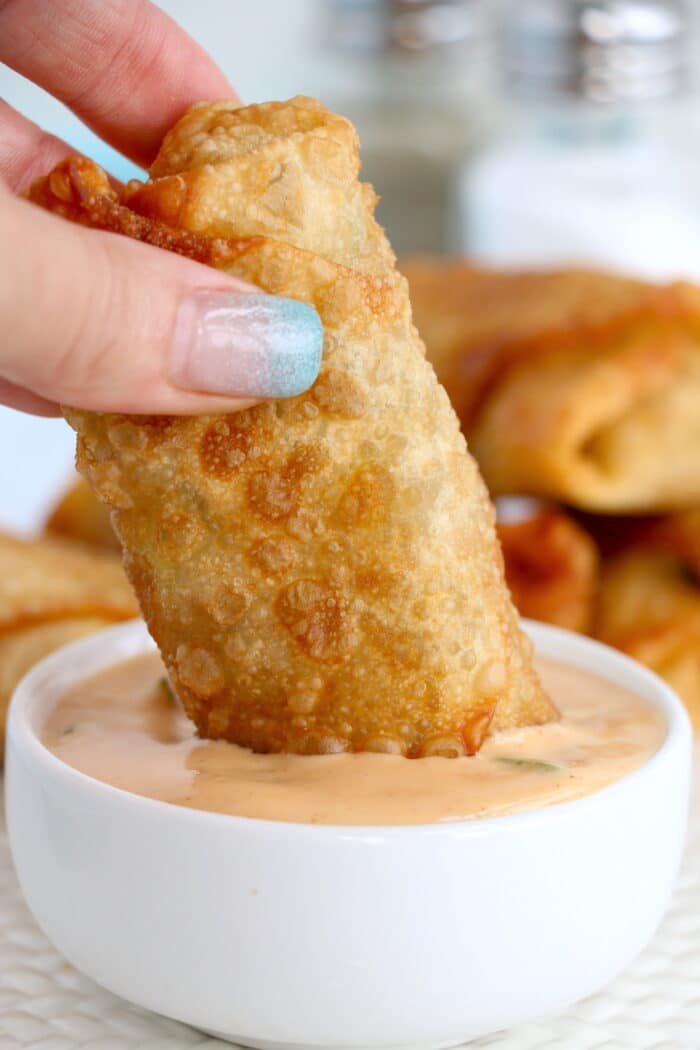 Dipping the Big Mac Egg Roll in sauce.