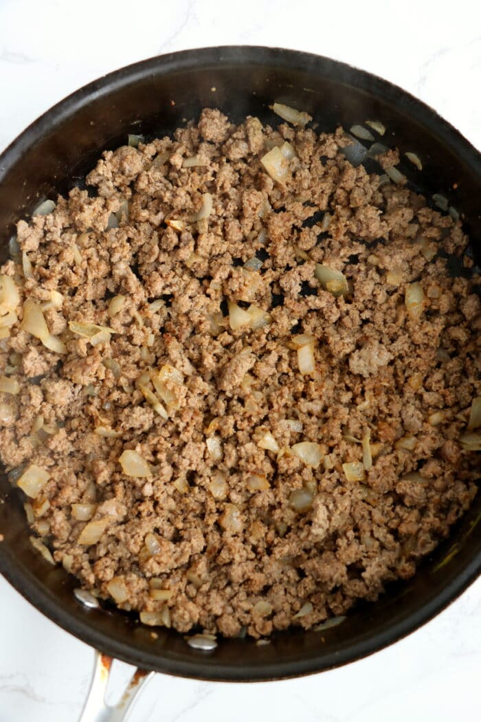 Cooking the ground beef.