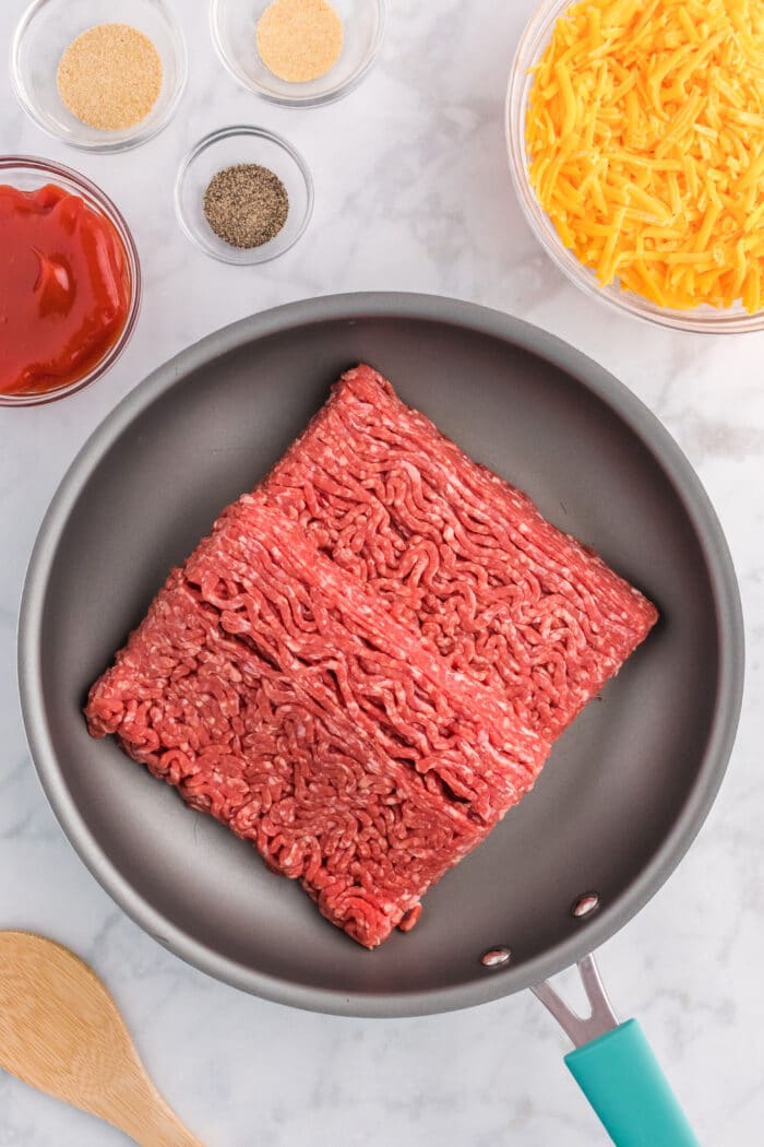 Cooking the ground beef.