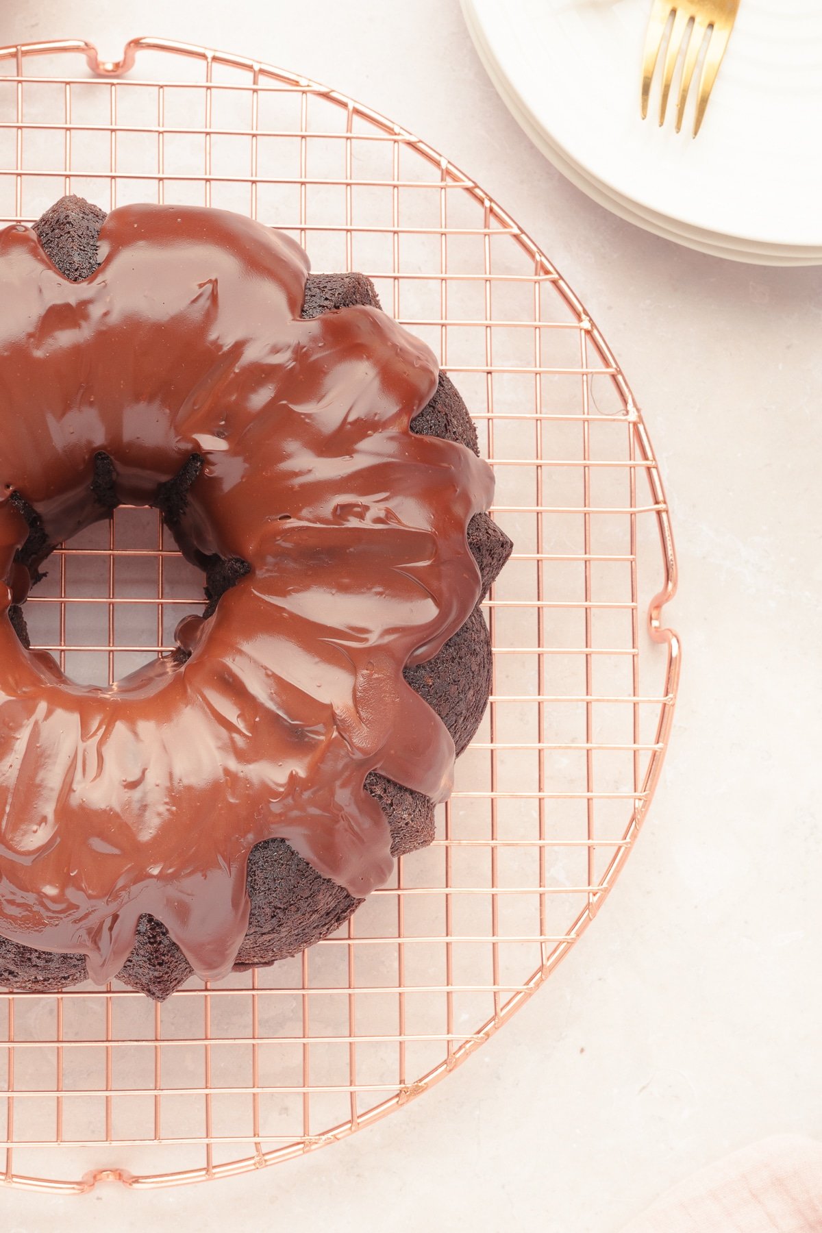 Overhead view of a chocolate bundt cake on a wire rack