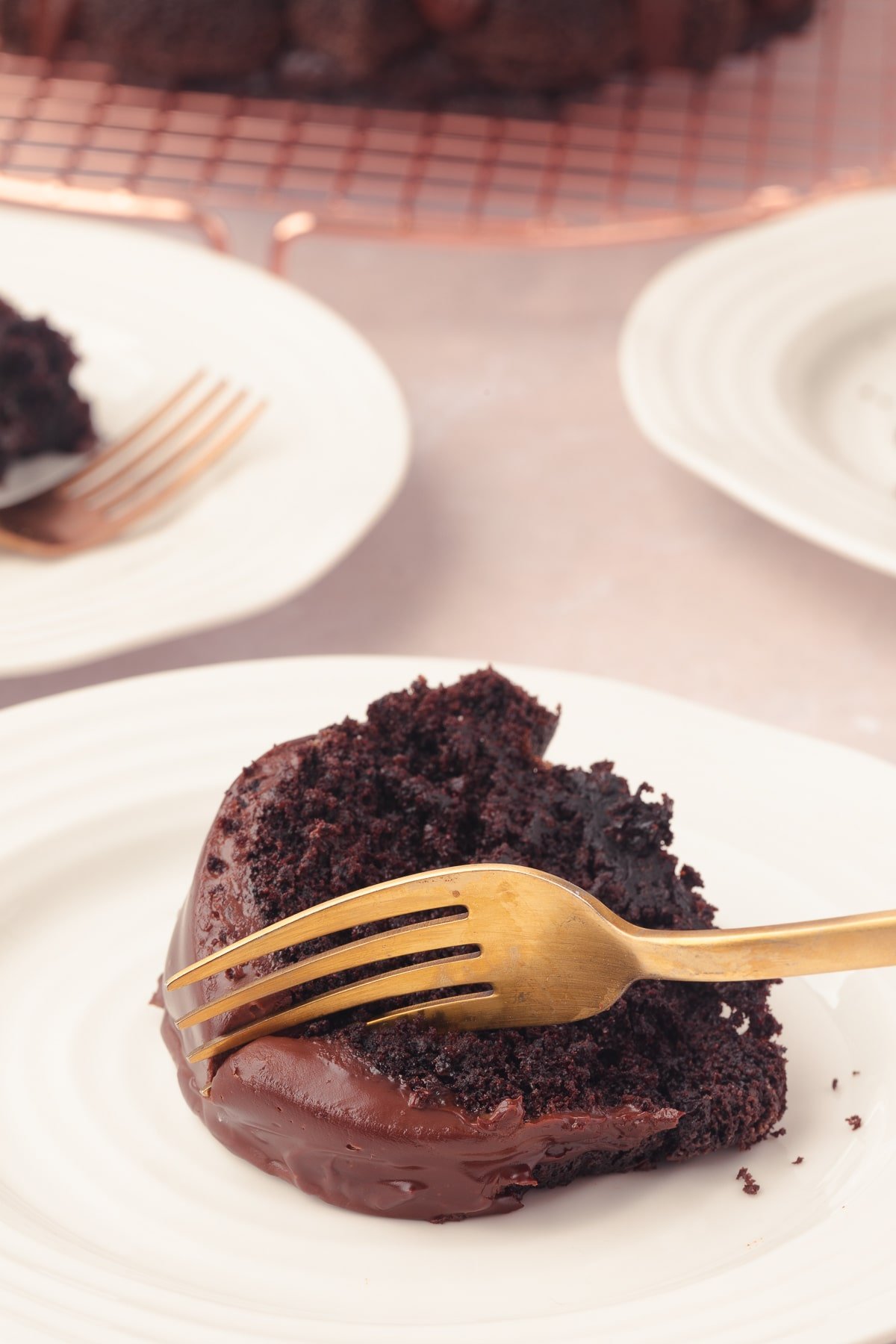 A fork cutting into a slice of chocolate bundt cake