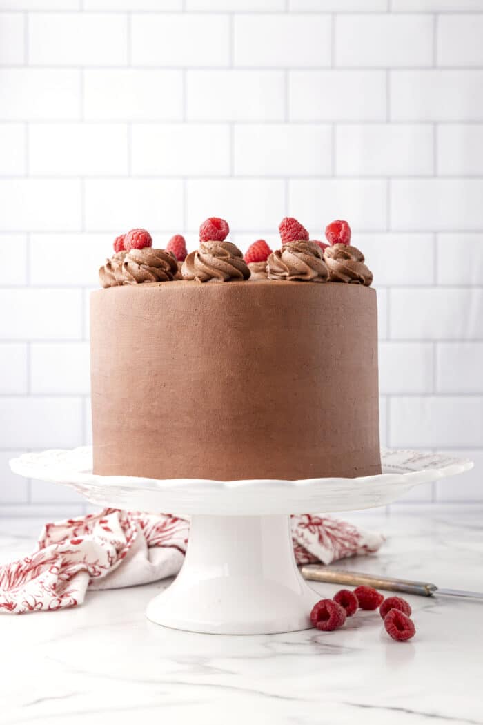 The Chocolate Raspberry Cake on a cake stand.