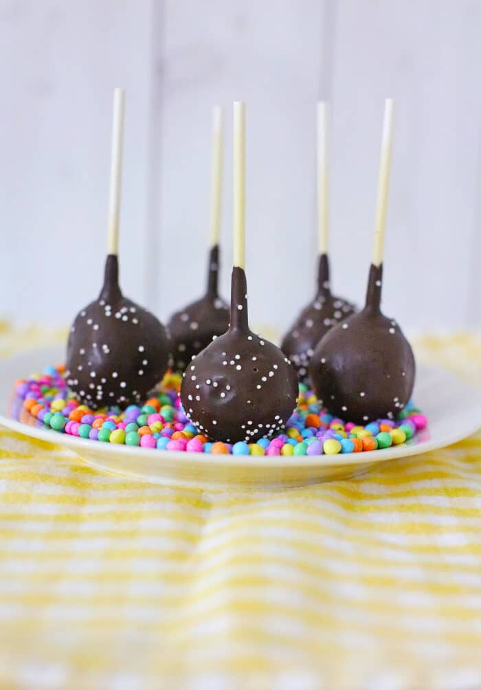 The Chocolate Cake Pops on a yellow table.