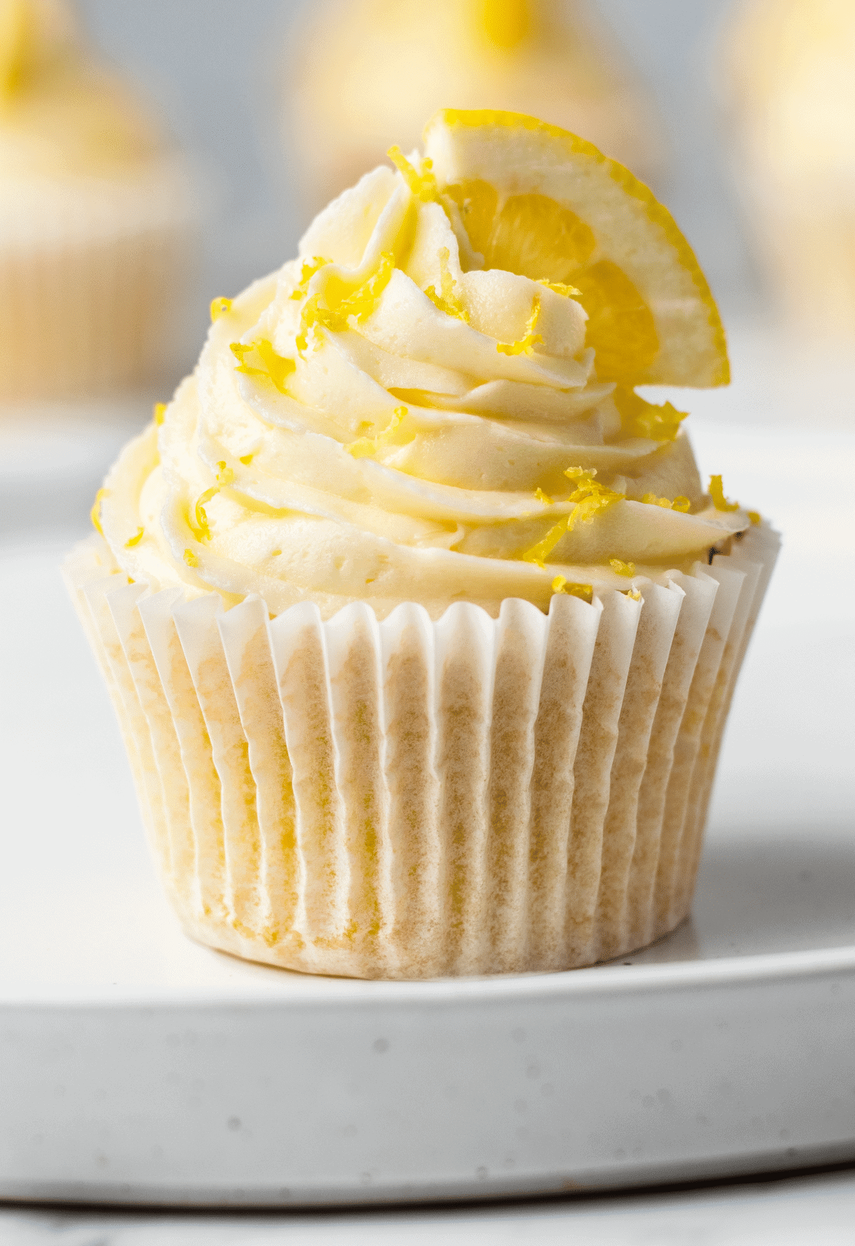 Front view of a lemon cupcake with frosting