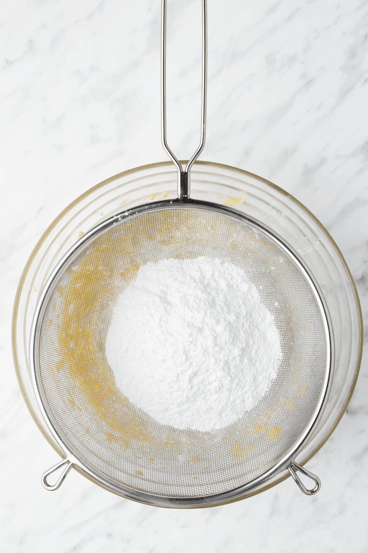 Powdered sugar being sifted into butter