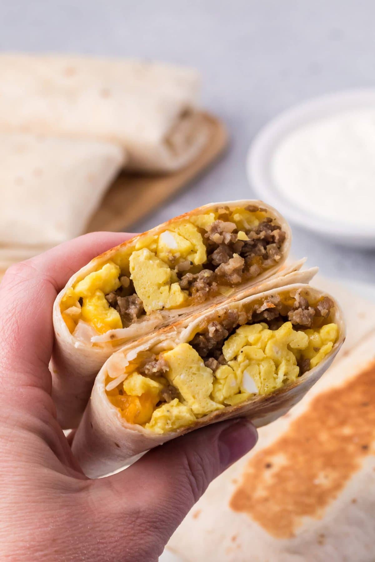 Holding a Breakfast Burritos.