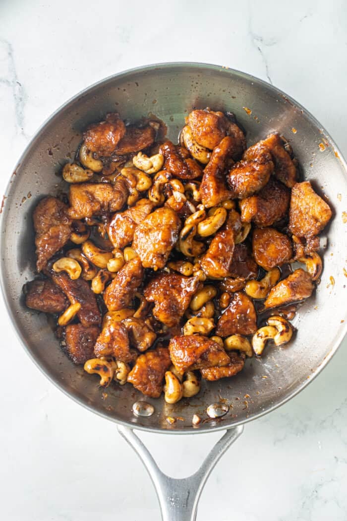 Tender, juicy pieces of chicken and toasted cashews are tossed in a sticky sweet-but-savory garlic sauce in this Cashew Chicken recipe. Chicken and cashews in a pan