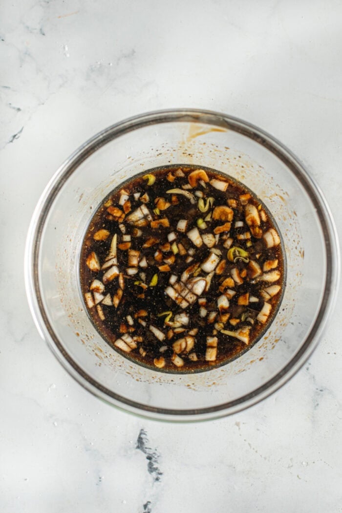 Tender, juicy pieces of chicken and toasted cashews are tossed in a sticky sweet-but-savory garlic sauce in this Cashew Chicken recipe. Garlic cashew chicken sauce in a bowl