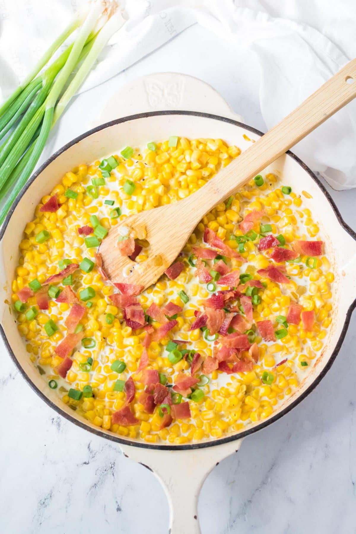 Cheesy Skillet Corn on a white table.