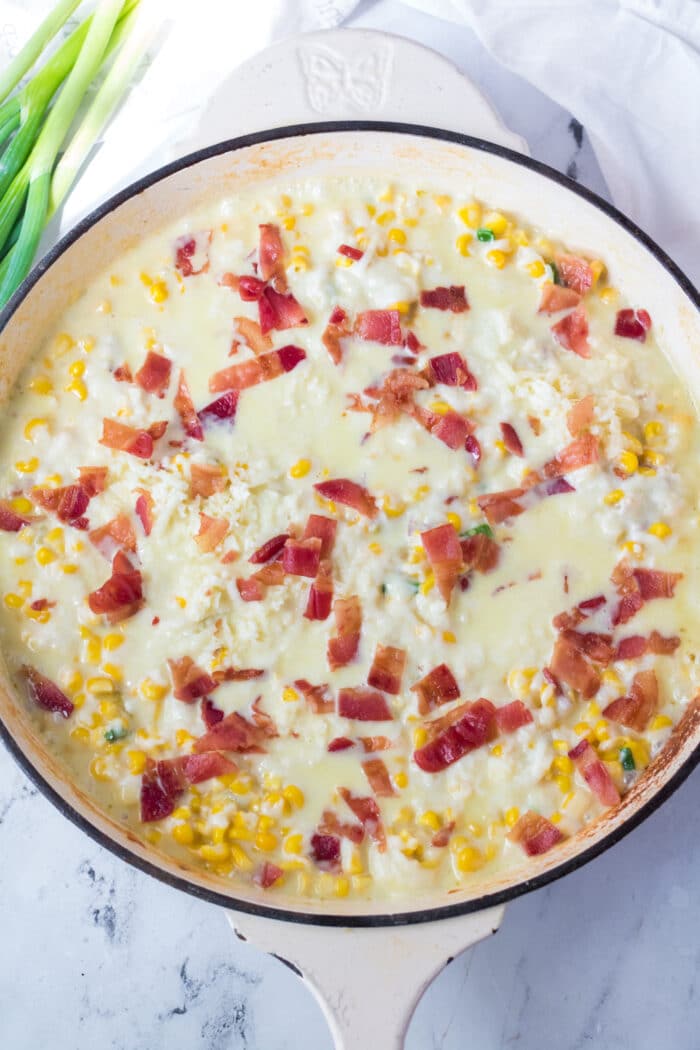 Overhead view of cheesy corn in the skillet