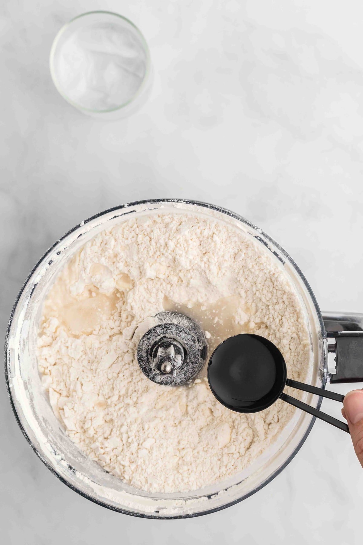 Water being added to flour in a food processor