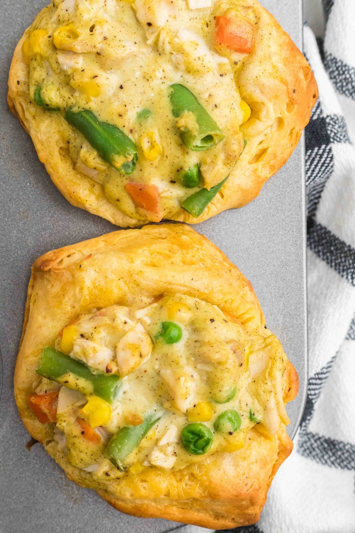 Close-up of two mini chicken pot pies in a muffin tin