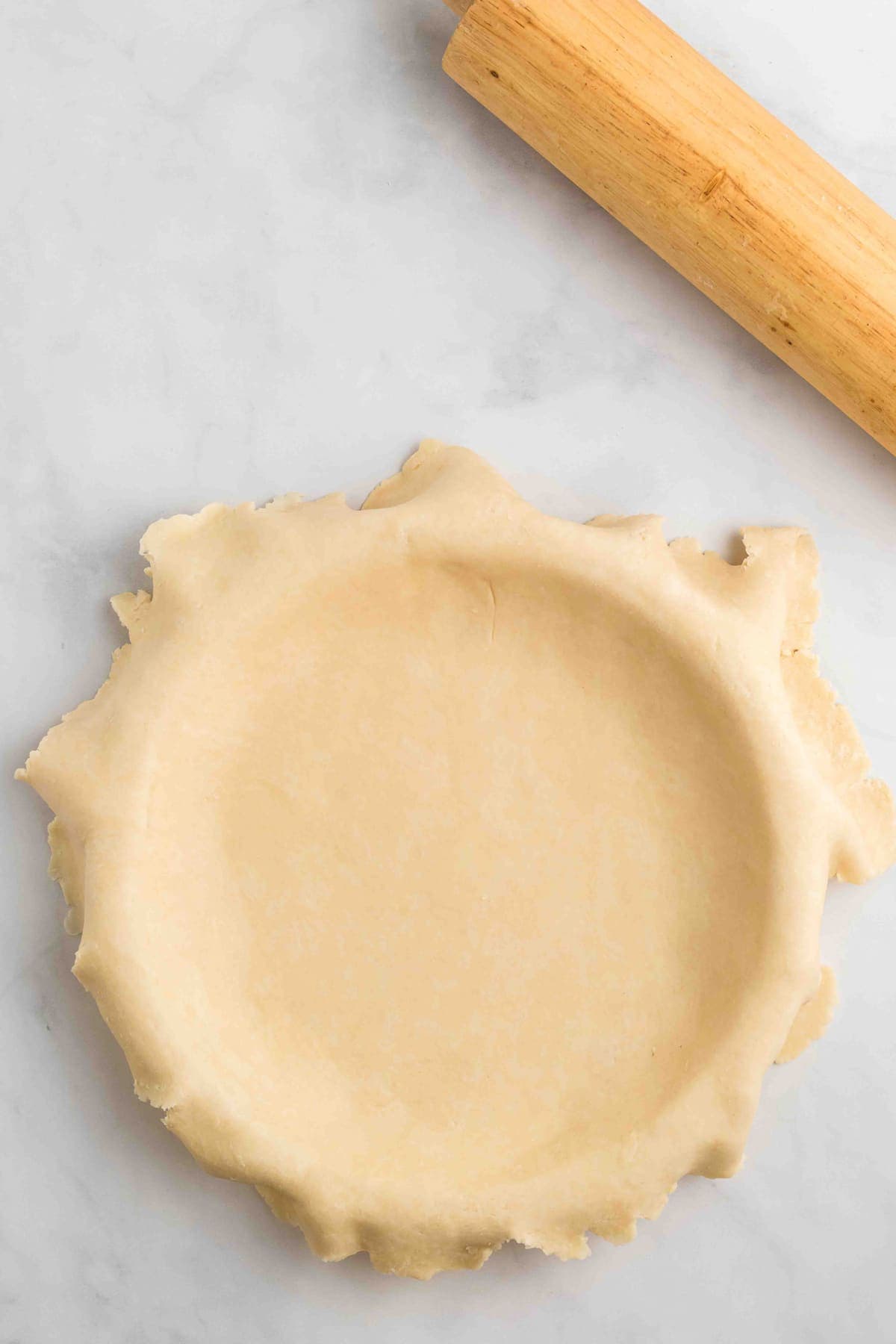 Pie crust rolled out over a pie pan