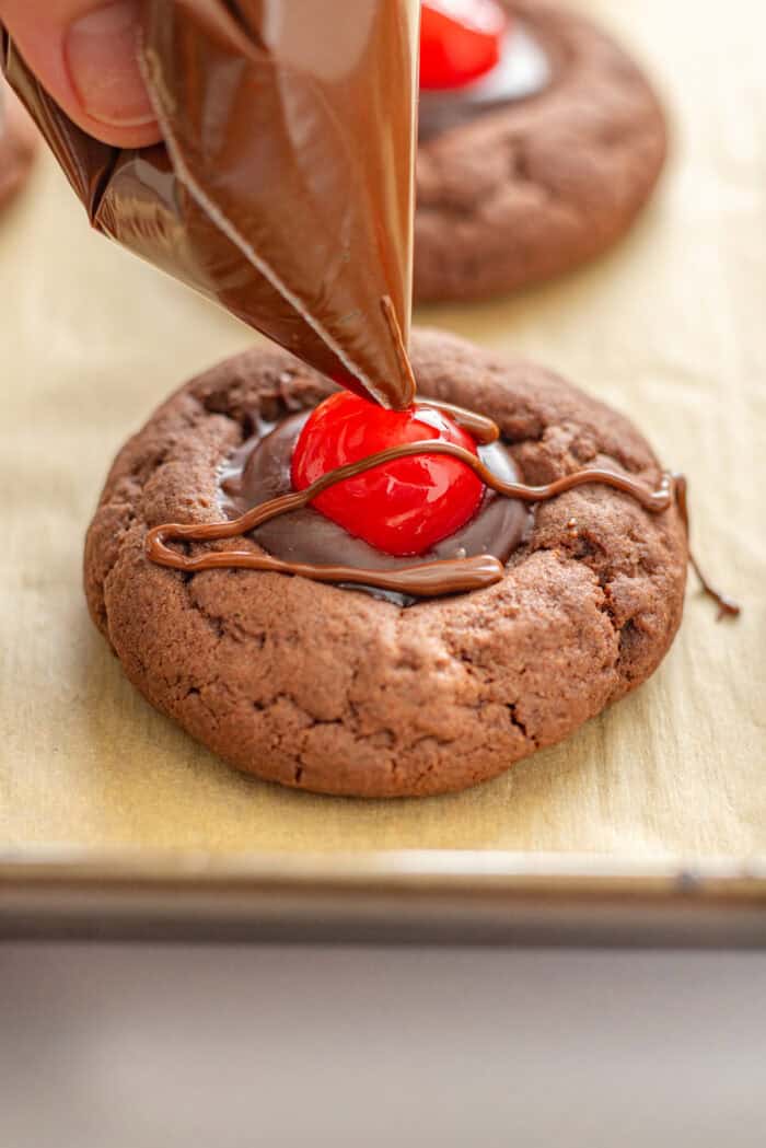 Drizzle chocolate over a chocolate cherry cookie