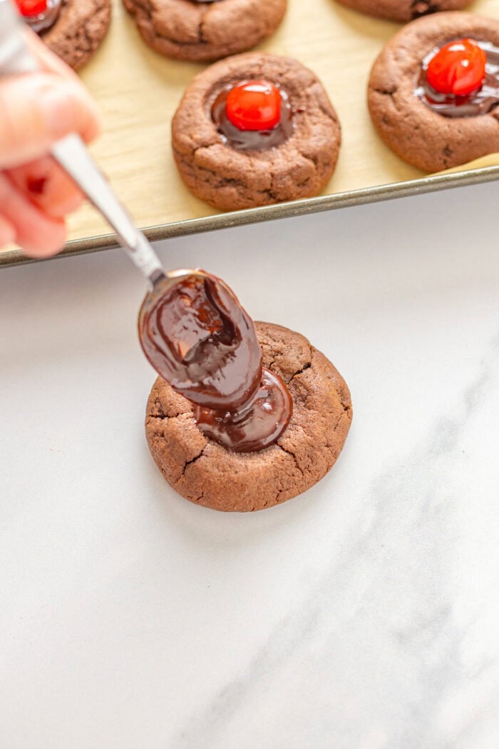 Spooning ganache into the center of a cookie